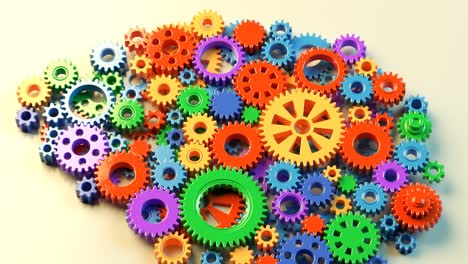 Technology-concept-of-the-human-brain-created-with-colorful-spinning-plastic-gears.-Silhouette-of-artificial-organ-showed-as-a-working-mechanism.-Perfect-for-educational-or-industrial-related-purposes
