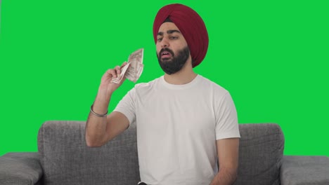 Sikh-Indian-man-counting-money-Green-screen