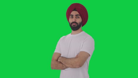 Portrait-of-Confident-Sikh-Indian-man-standing-crossed-hands-Green-screen