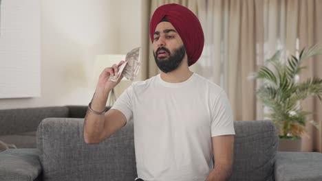 Sikh-Indian-man-counting-money
