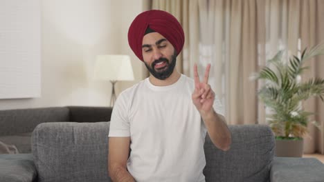Happy-Sikh-Indian-man-showing-victory-sign