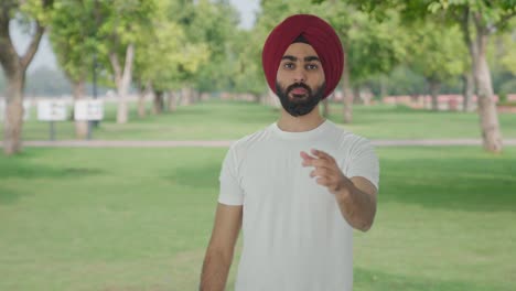 Upset-Sikh-Indian-man-seeing-shocking-news-in-park
