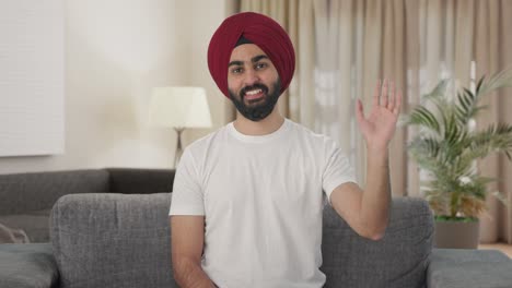Happy-Sikh-Indian-man-waving-Hi-to-the-camera