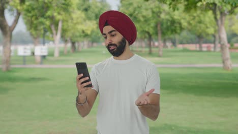 Sikh-Indian-man-talking-on-video-call-in-park