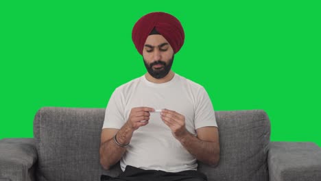 Hombre-Indio-Sikh-Enfermo-Usando-Un-Termómetro-Para-Controlar-La-Pantalla-Verde-De-La-Fiebre