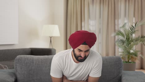 Sick-Sikh-Indian-man-suffering-from-stomach-pain