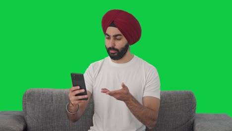 Sikh-Indian-man-talking-on-video-call-Green-screen