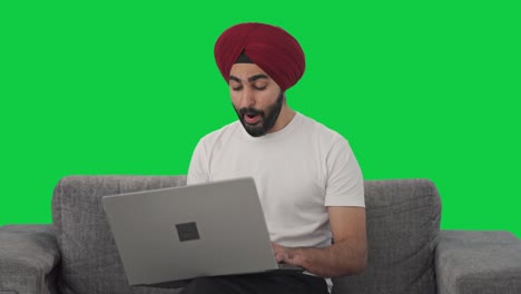 Sleepy-Sikh-Indian-man-using-Laptop-Green-screen