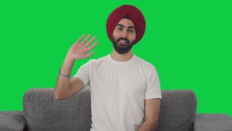 Fröhlicher-Sikh-Indianer-Sagt-Hallo,-Grüner-Bildschirm