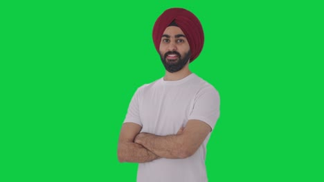 Portrait-of-Happy-Sikh-Indian-man-standing-crossed-hands-Green-screen
