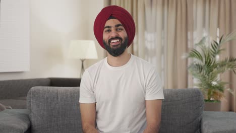 Indian-Sikh-Indian-man-laughing-while-watching-TV
