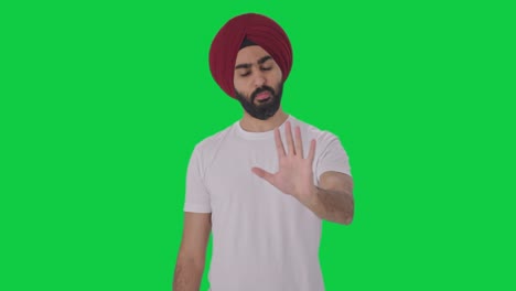 Angry-Sikh-Indian-man-stopping-someone-Green-screen