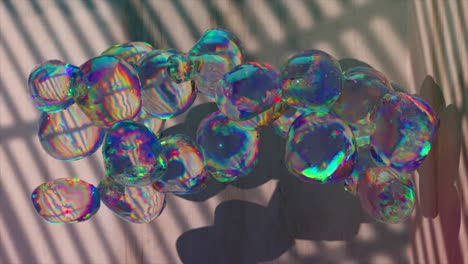 The-concept-of-transformation.-Large-transparent-rainbow-bubbles-are-blown-from-a-shelf-on-the-wall.-Wood-and-stone-transform-into-a-bubble.-Shadow-in-the-background.-3D-animation.