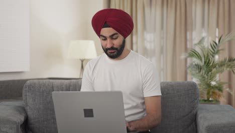 Happy-Sikh-Indian-man-using-Laptop