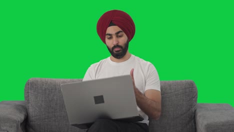 Angry-Sikh-Indian-manager-shouting-on-video-call-on-Laptop-Green-screen