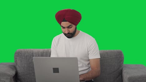 Tensed-Sikh-Indian-man-using-Laptop-Green-screen