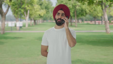 Sikh-Indian-man-talking-on-phone-in-park