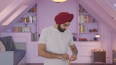 Sad-Sikh-Indian-man-measuring-waist-using-Inch-tape