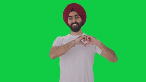 Happy-Sikh-Indian-man-showing-heart-sign-Green-screen