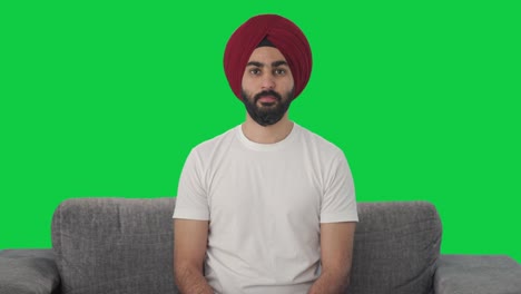 Serious-Sikh-Indian-man-looking-Green-screen