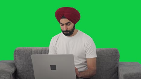 Confused-Sikh-Indian-man-using-Laptop-Green-screen