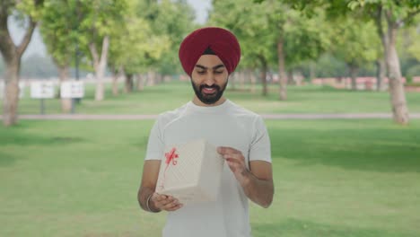 Happy-Sikh-Indian-man-receives-a-gift-in-park
