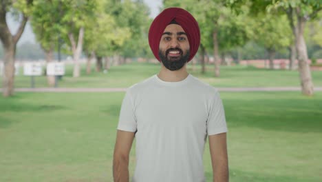 Happy-Sikh-Indian-man-showing-thumbs-up-in-park
