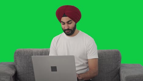 Happy-Sikh-Indian-man-using-Laptop-Green-screen