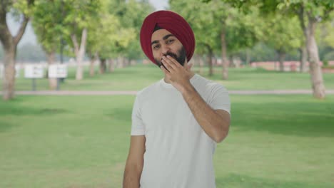 Happy-Sikh-Indian-man-giving-flying-kisses-in-park