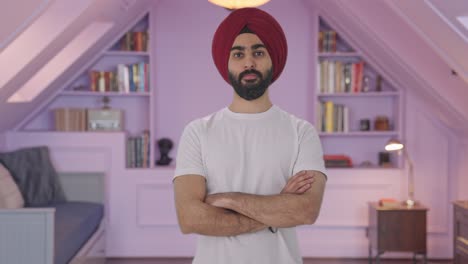 Confident-Sikh-Indian-man-standing-crossed-hands