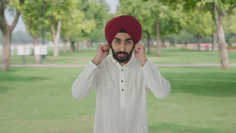 Guilty-Sikh-Indian-man-saying-sorry-and-apologizing-in-park