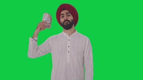Hombre-Indio-Sij-Egoísta-Usando-Dinero-Como-Pantalla-Verde-De-Ventilador