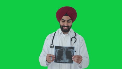 Happy-Sikh-Indian-doctor-checking-X-ray-scan-Green-screen