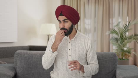Sikh-Indian-man-taking-medicine
