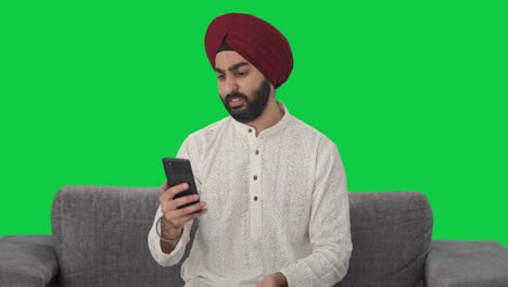 Angry-Sikh-Indian-man-shouting-on-video-call-Green-screen