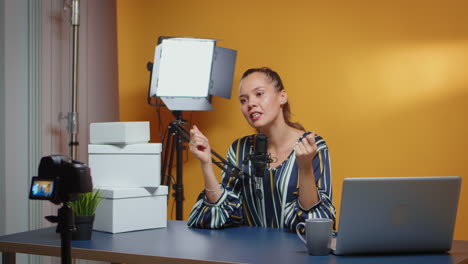 Influencer-talking-to-camera-and-giveaway-boxes-are-on-the-desk