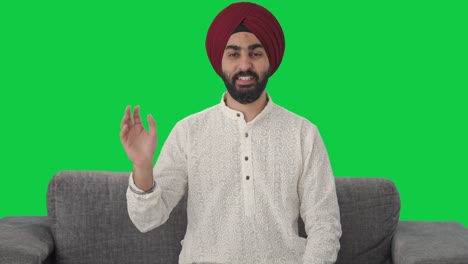 Fröhlicher-Sikh-Indianer-Winkt-Hallo,-Grüner-Bildschirm