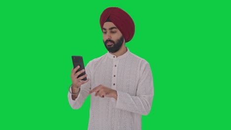 Sikh-Indian-man-talking-on-video-call-Green-screen