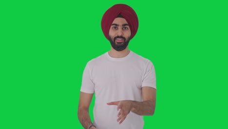Fröhlicher-Sikh-Indianer,-Der-Auf-Grünem-Bildschirm-Spricht