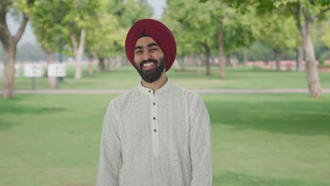 Sikh-Indian-man-laughing-on-someone-in-park