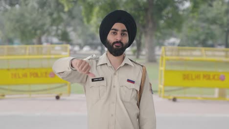 Disappointed-Sikh-police-Indian-man-showing-thumbs-down