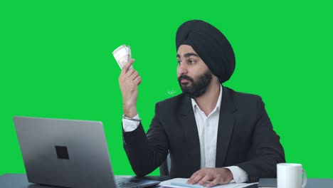 Egoistic-Sikh-Indian-businessman-using-money-as-fan-Green-screen