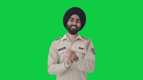 Happy-Sikh-Indian-police-man-clapping-and-appreciating-Green-screen