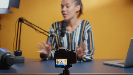 Selective-focus-on-camera-while-social-media-star-records-an-new-podcast-episode