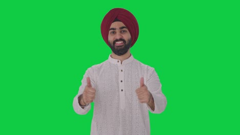 Fröhlicher-Sikh-Indianer-Zeigt-Daumen-Nach-Oben-Auf-Grünem-Bildschirm