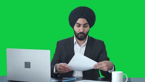 Serious-Sikh-Indian-businessman-talking-to-employees-Green-screen