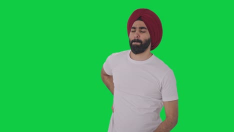 Hombre-Indio-Sikh-Enfermo-Que-Sufre-De-Dolor-De-Espalda-Pantalla-Verde