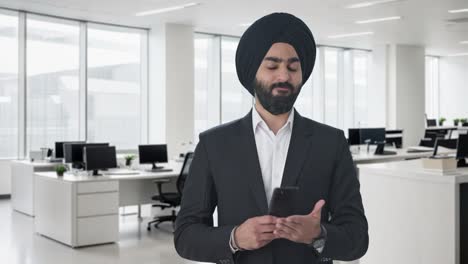 Angry-Sikh-Indian-businessman-texting-someone