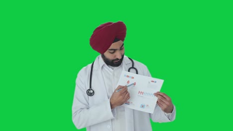 Serious-Sikh-Indian-doctor-explaining-medical-reports-to-patient-Green-screen