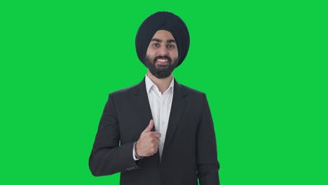 Happy-Sikh-Indian-businessman-showing-thumbs-up-Green-screen